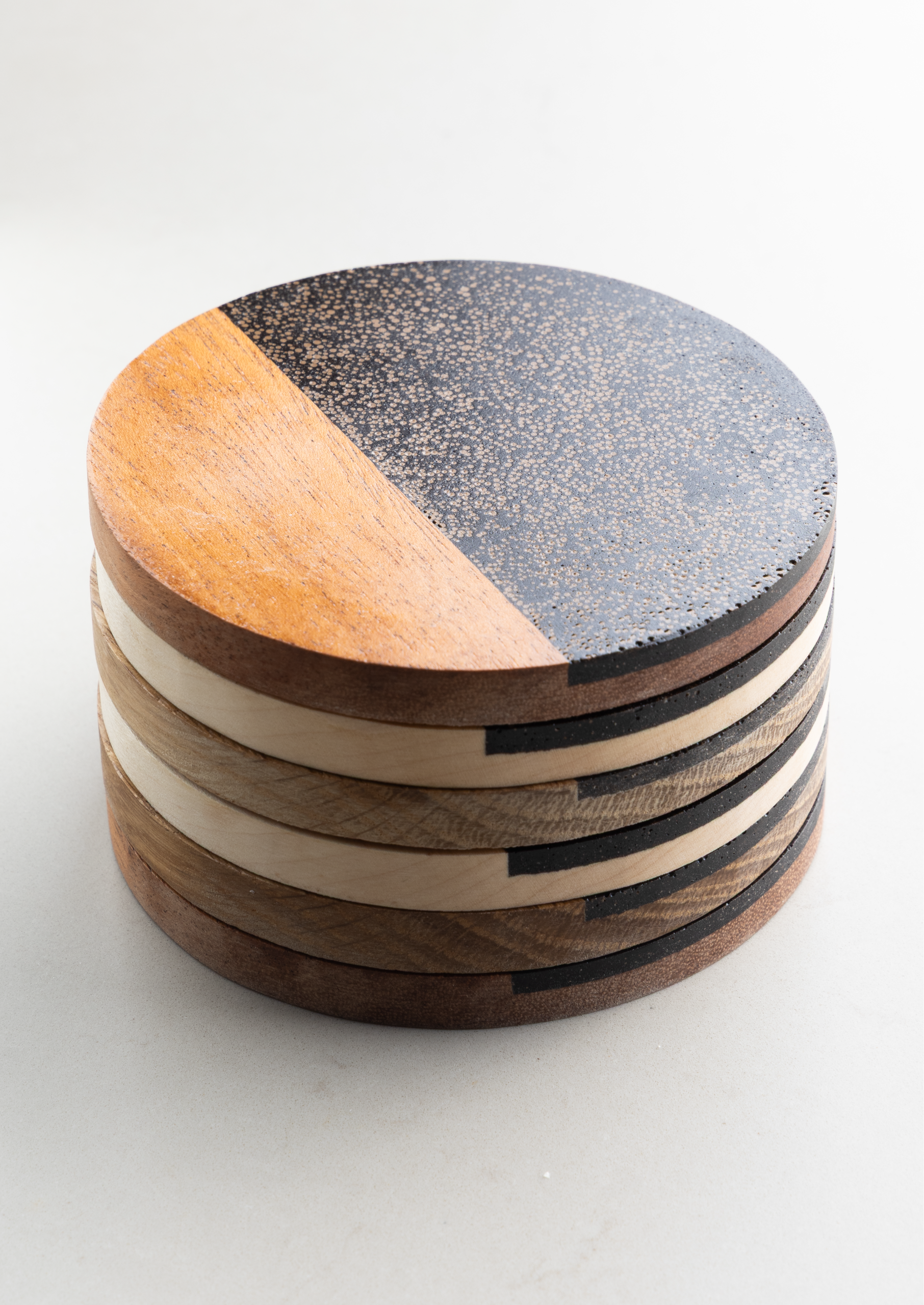 Detailed side view of stacked coasters showing coffee shell texture made from reclaimed coffee grounds