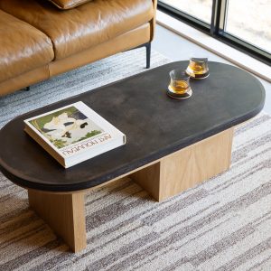 Bunn Pill Coffee Table with Maple Made from Reclaimed Coffee Grounds Oval pill-shaped coffee table with coffee shell finish and maple wood base styled with ceramic accessories